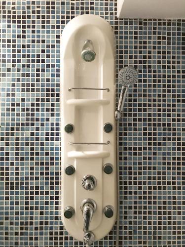 a sink in a tiled bathroom with a shower at Planta baja centro Cadaqués in Cadaqués