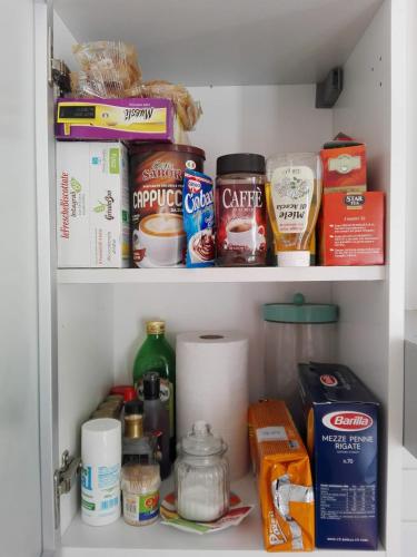 a refrigerator shelf filled with food and other food items at Casa Martini in Venice
