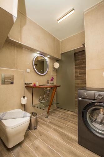 a bathroom with a washing machine and a sink at Limonero New City Apartment 1 with Private Parking in Lefkada