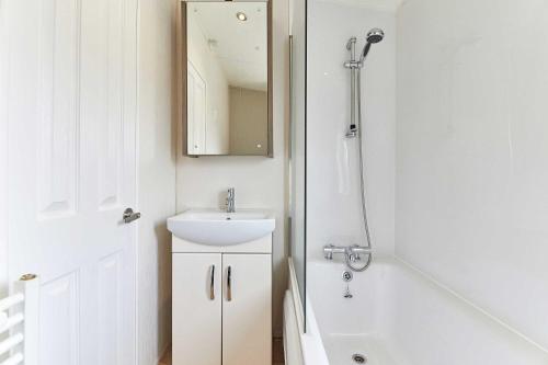 a white bathroom with a sink and a mirror at Host & Stay - Yolo Lodge in Felton