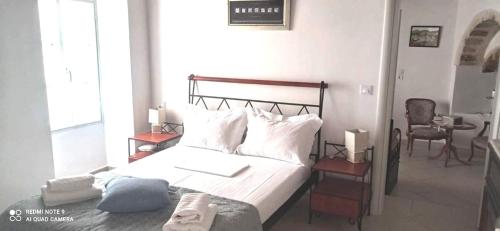 a bedroom with a large bed and a chair at Chora View in Kýthira
