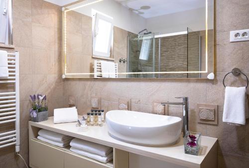 a bathroom with a white sink and a mirror at 5 Bedroom Villa with Private Pool in Poljice