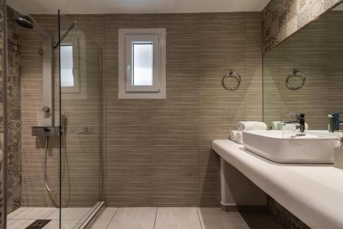 a bathroom with a sink and a shower at Alexandros Village in Adamas