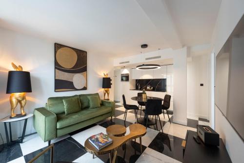 a living room with a green couch and a table at O'Lord, 4 Etoiles, Residence de Luxe Champs-Elysees in Paris