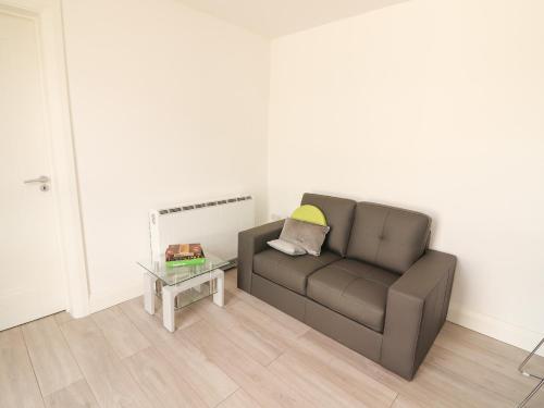 a living room with a couch and a table at Coolnaharragill Lower Annexe in Killarney
