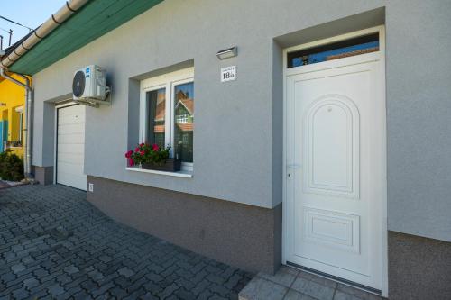 a white door on the side of a building at Cecey Apartman in Eger