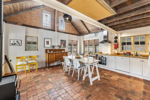 a kitchen with a table and chairs in it at Benny's Retreat Luxury Bushland Escape in Clare