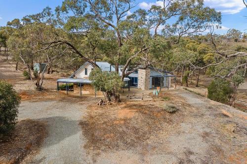 a small house in the middle of a forest at Benny's Retreat Luxury Bushland Escape in Clare