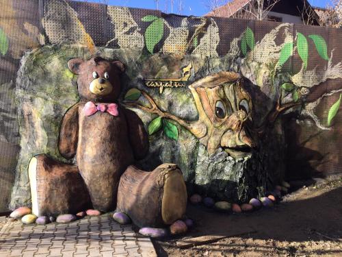 a mural of a teddy bear and a tree at HOTEL CARPAT INN in Azuga