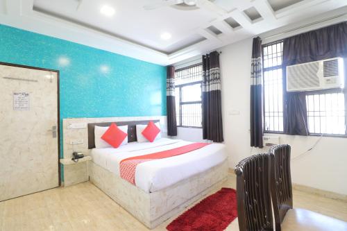 a bedroom with a bed with red pillows on it at Hotel Airlift at Delhi Airport in New Delhi