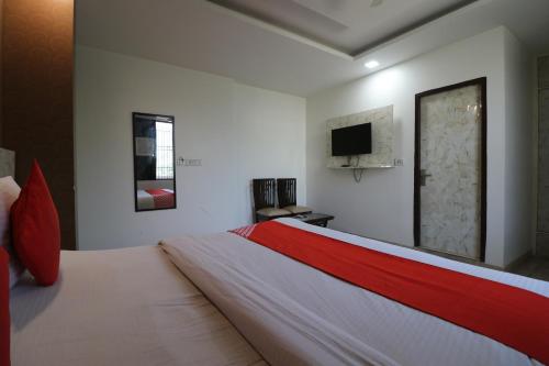 a bedroom with a bed and a tv on the wall at Hotel Airlift at Delhi Airport in New Delhi
