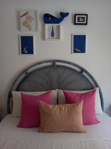 a bed with a white bedspread and pillows on top of it at Carilla B&B in Carloforte