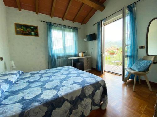a bedroom with a bed and a sliding glass door at la madonnina in Querceta