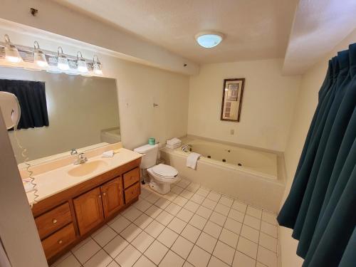 a bathroom with a sink and a tub and a toilet at Town Inn in Bordentown