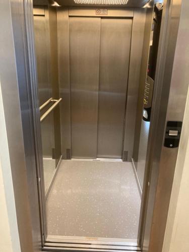 a metal elevator in a building with its door open at Frühstückspension Josefinum in Bad Aussee