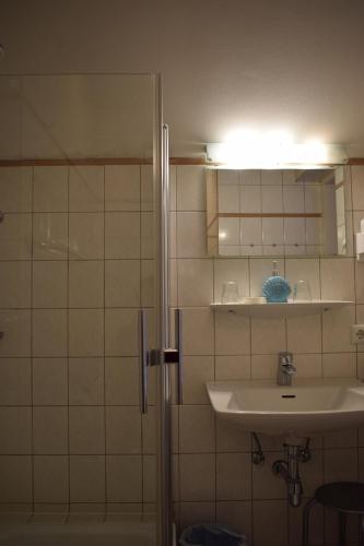 a bathroom with a sink and a shower at Frühstückspension Josefinum in Bad Aussee