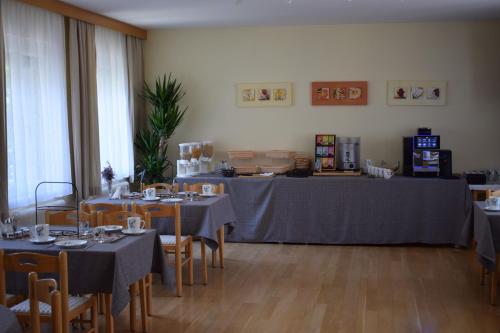 a dining room with tables and chairs with gray table cloth at Frühstückspension Josefinum in Bad Aussee