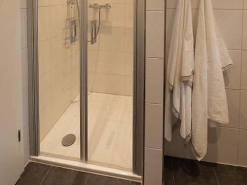 a shower with a glass door in a bathroom at Hof Weuste in Attendorn