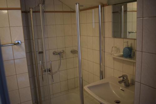a bathroom with a shower and a sink at Frühstückspension Josefinum in Bad Aussee