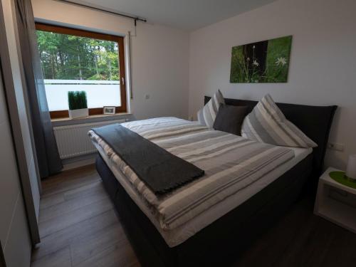 een groot bed in een kamer met een raam bij Hof Weuste in Attendorn