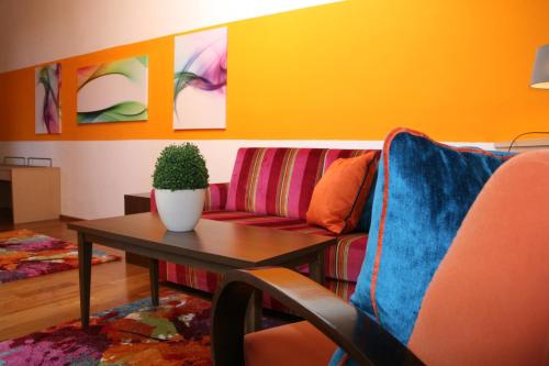 a living room with a couch and a table at Hotel Schloss Berg in Berg am Starnberger See