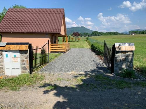 a gate leading to a building with a fence at Rekreační pobyt in Tichá
