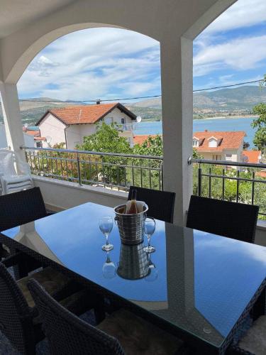 a table with wine glasses on a balcony with a view at Genesis in Trogir
