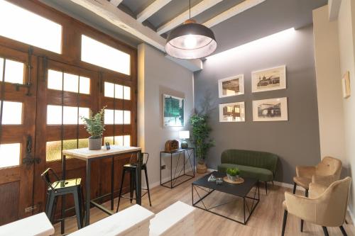 a living room with a table and chairs at Alda Centro Pamplona in Pamplona