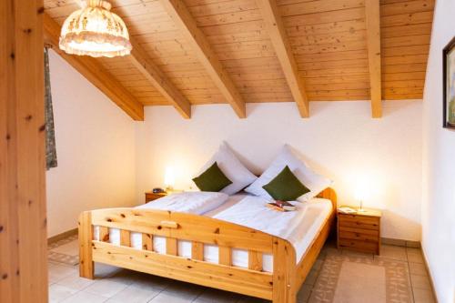 a bedroom with a large wooden bed in a room at Ferienhaus Killian in Bischofsmais