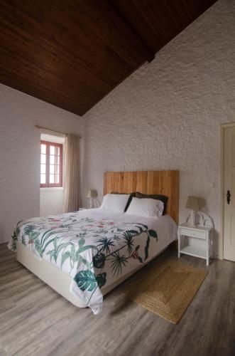 a bedroom with a large bed and a window at Quinta do Mirante 1785 in Ponta Delgada