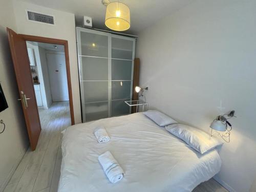 a bedroom with a white bed with two pillows at On The Lake in Tiberias