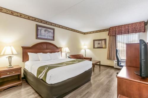 a hotel room with a bed and a television at Quality Inn & Suites Bel Air I-95 Exit 77A in Bel Air