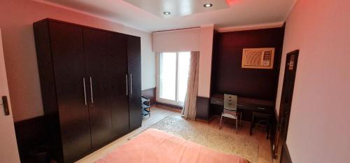 - une chambre avec un lit, un bureau et une fenêtre dans l'établissement Zamlek Nile view, au Caire