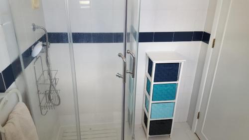a shower with a glass door in a bathroom at apartamento cinco reis in Angra do Heroísmo