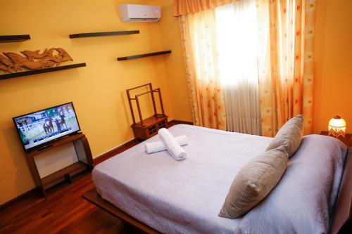 a bedroom with a bed and a television in it at Magnifica Planet Costa Dorada in Cambrils