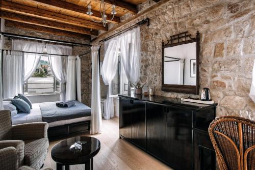 a bedroom with a bed and a mirror at Villa Allure of Dubrovnik in Dubrovnik