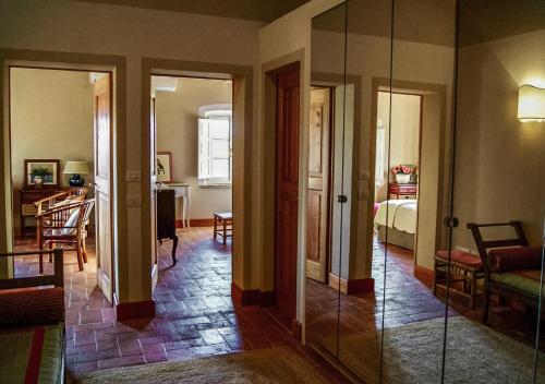 a hallway with a room with a bed and a mirror at Casa Terzerie in Braccagni