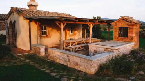 a house with a wooden roof and a patio at Casa Terzerie in Braccagni