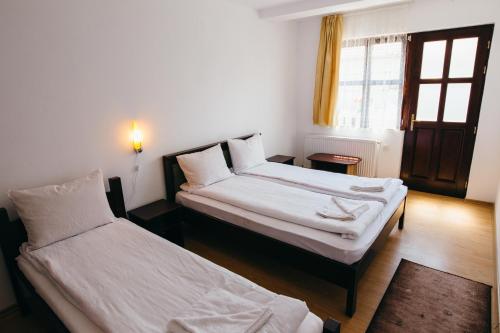 En eller flere senge i et værelse på Vendégváró Panzió