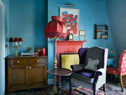 a living room with a chair and a fire place at The Zetter Clerkenwell in London