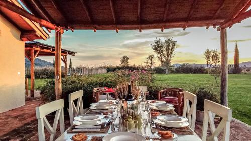 a table with plates and dishes on it on a patio at Casa Terzerie in Braccagni