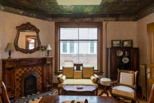 a living room with a fireplace and a mirror at Moulin Rouge House Bed and Breakfast in Mankato