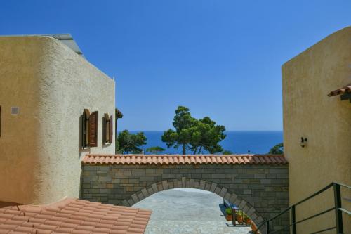an archway in a building with a view of the ocean at Galini Apartments in Achlia