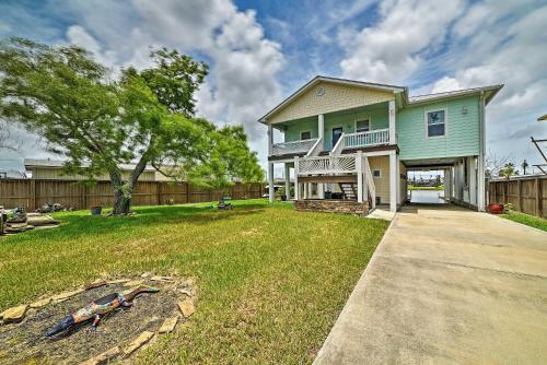 a house with a yard with a fence at Waterfront Rockport Home with Dock and 3 Kayaks! in Rockport