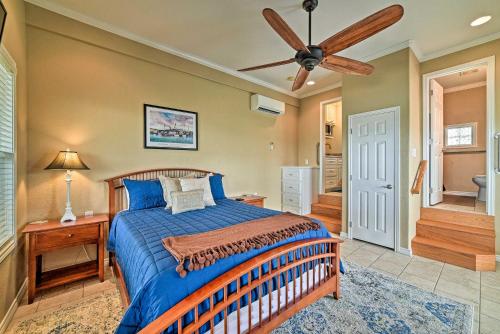 a bedroom with a bed and a ceiling fan at Waterfront Rockport Home with Dock and 3 Kayaks! in Rockport