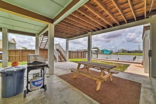 a patio with a picnic table and a grill at Waterfront Rockport Home with Dock and 3 Kayaks! in Rockport