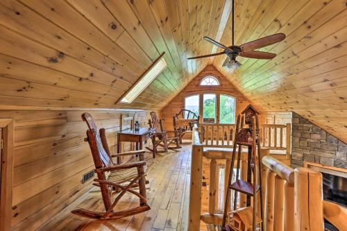 a dining room in a log cabin with a ceiling fan at Porch, Fire Pit and Valley Views Blakely Cabin! in Blakely