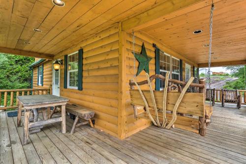 a cabin with a bench and a table on a porch at Porch, Fire Pit and Valley Views Blakely Cabin! in Blakely