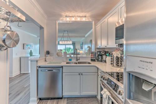 a kitchen with white cabinets and a sink at Harbor Island Beach Retreat - Steps to Ocean! in Oceanmarsh Subdivision