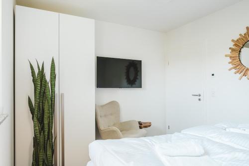 En eller flere senger på et rom på Dünenquartier Apartment 28